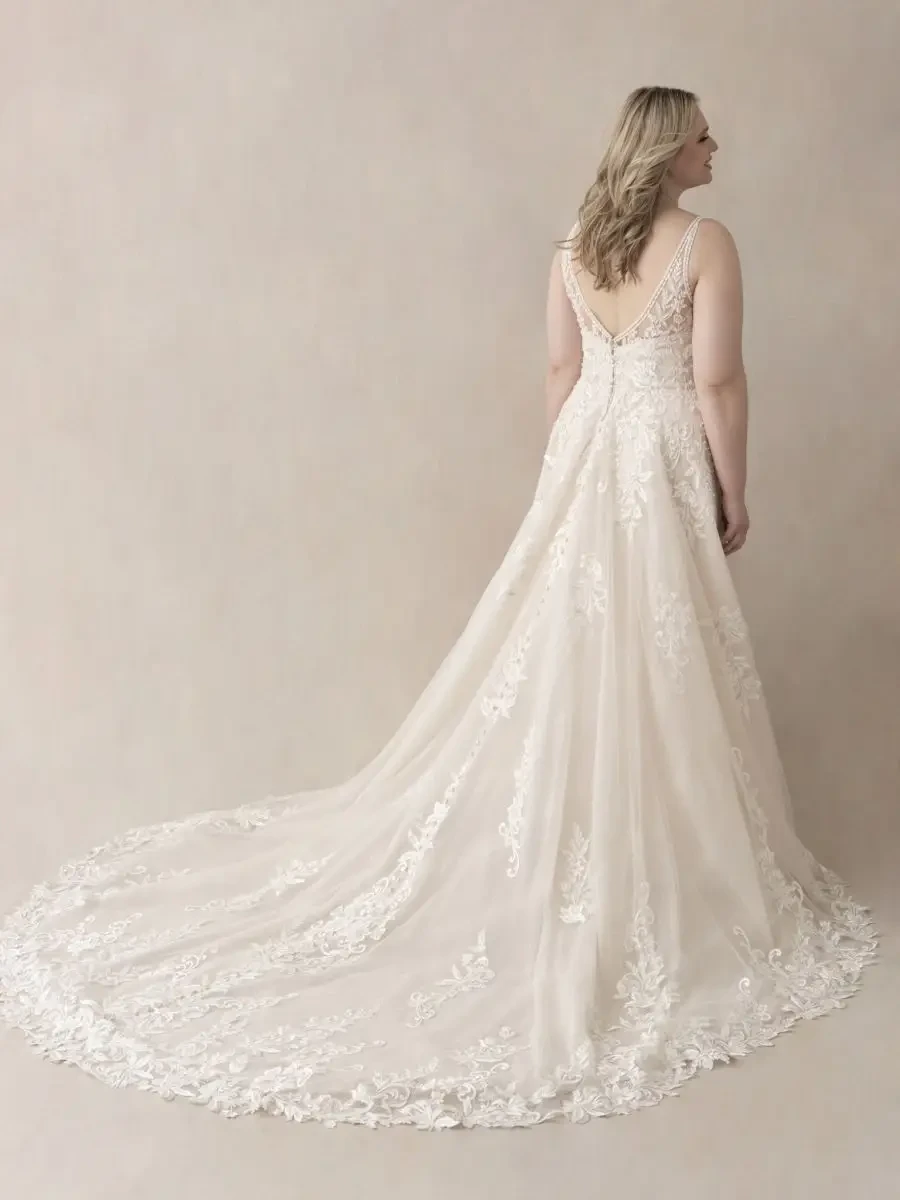 model is wearing a sleeveless lace bridal gown