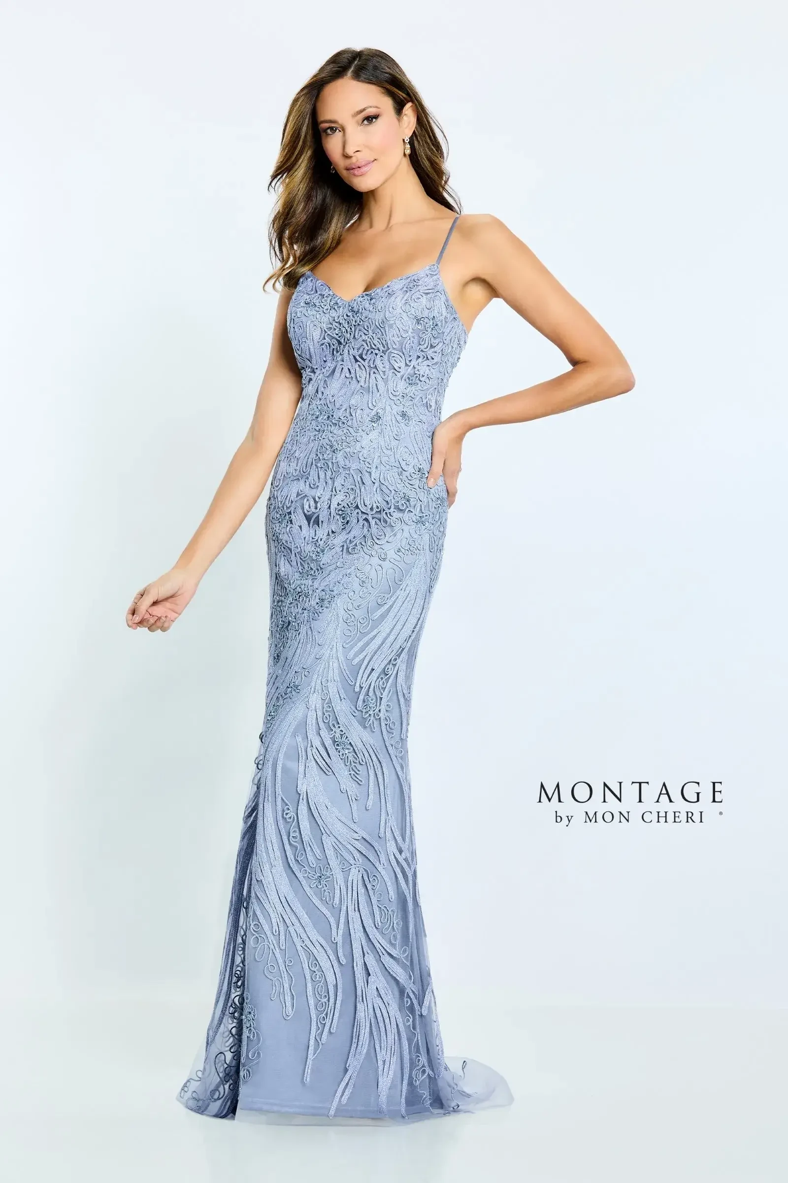 A woman wearing a fitted, elegant light blue evening gown with intricate detailing and a mermaid silhouette.